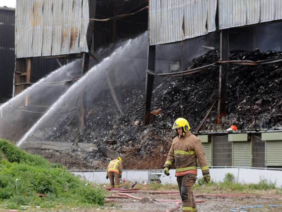 Firefighters were still working to dampen the blaze at Alex Smiles on Friday.