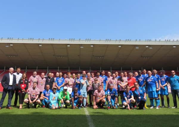 The two teams from the Salvation Army game line-up at the Stadium of Light.