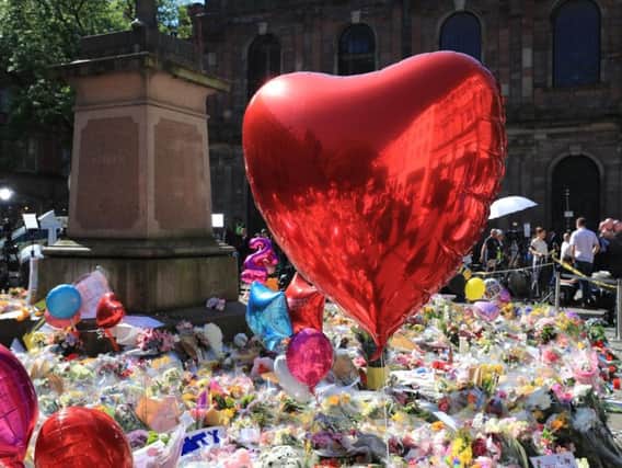 Tributes left in St Ann's Square, Manchester, in the days after the bombing. Picture by Peter Byrne/PA Wire