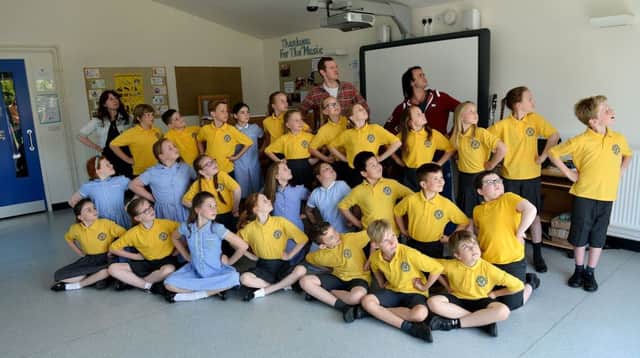 Royal Shakespeare Company practitioners (left to right) Anna Marsland, Joe Cummings and Chris Piper with pupils from Our Lady, Queen of Peace Roman Catholic Voluntary Aided Primary School.