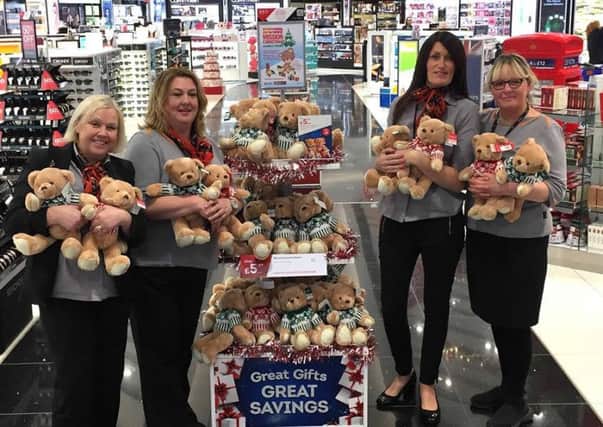 The staff at Newcastle Airport donating the bears.