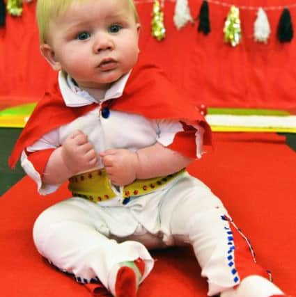 Five-month-old Ethan Miller does his Elvis impression for charity.