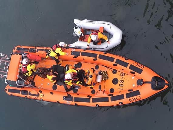 Hartlepool RNLI inshore lifeboat with the two casualties on board and the dinghy alongside at the Ferry Road lifeboat station where a crew member assisted with the recovery. RNLI/Tom Collins.